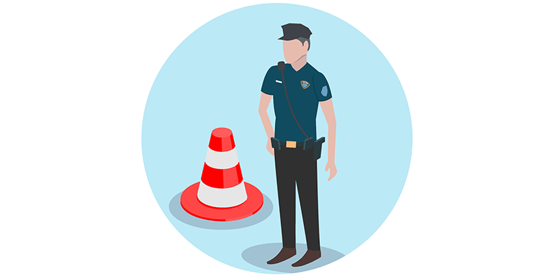 Police officer next to a safety cone